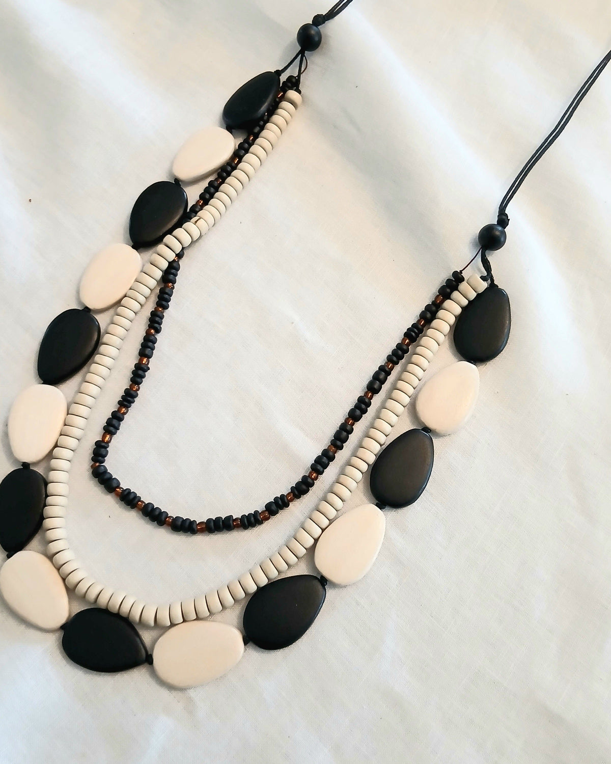 Cinnamon Creations Cinnamon Black Cream 3 Row Woodbead Rope Necklace n6-5396ab Cinnamon Black Cream 3 Row Woodbead Rope Necklace Splash Swimwear Accessories 1000030598