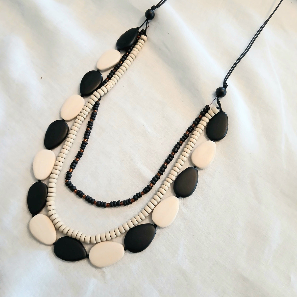 Cinnamon Creations Cinnamon Black Cream 3 Row Woodbead Rope Necklace n6-5396ab Cinnamon Black Cream 3 Row Woodbead Rope Necklace Splash Swimwear Accessories 1000030598