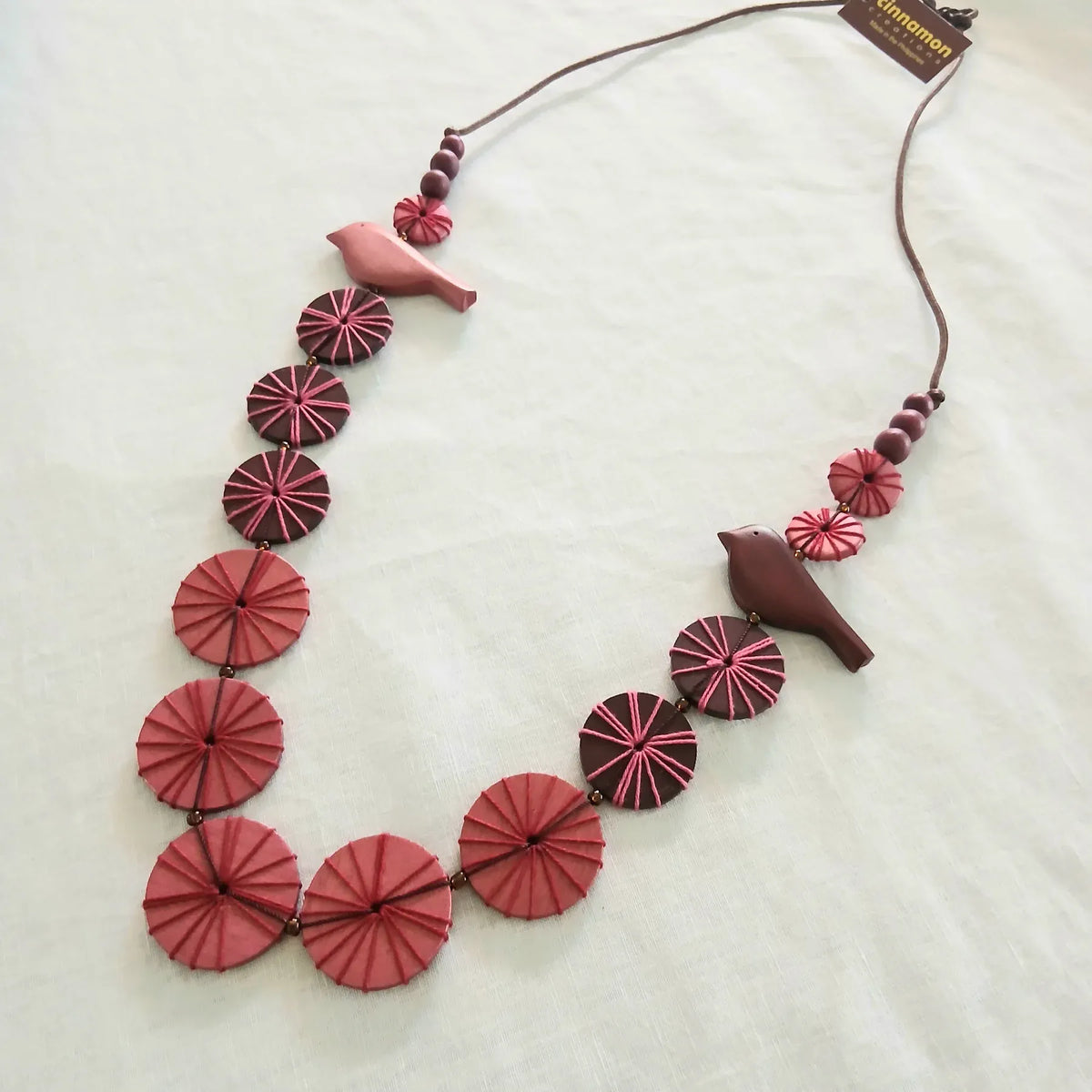 Cinnamon Creations Cinnamon Multipink Wood Bird Button Necklace n7-696d Cinnamon Multipink Wood Bird Button Necklace Splash Swimwear Accessories 1000030592